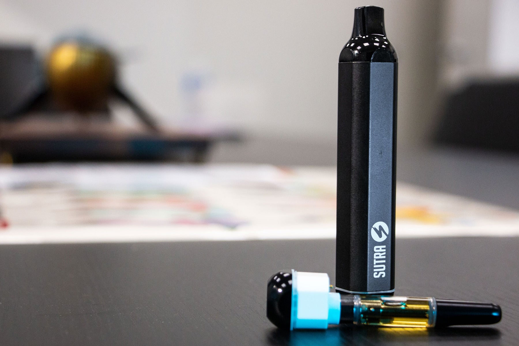 Sutra Silo standing on office table with a cartridge nearby