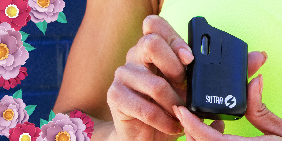 woman holding the Sutra Mini Vaporizer with flowers